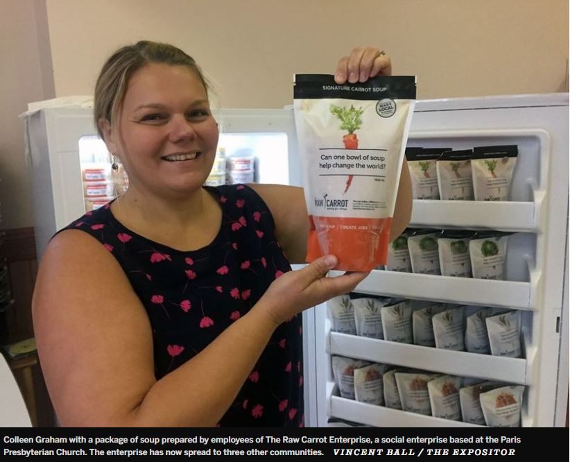 Colleen Graham (founder), holding a raw carrot soup package and smiling.