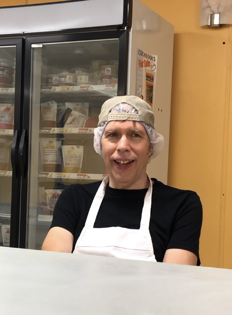 Man talking in front of a freezer