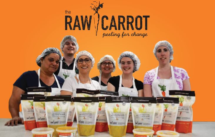 The Raw Carrot log with six MCCO staff members smiling with 19 soups surrounding them!